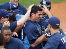 Tampa Bay Rays player Justin Ruggiano, centre, is congratulated by teammates after hitting the game-winning RBI single in the 10th inning of a spring training baseball game against the Toronto Blue Jays in Port Charlotte, Fla., Tuesday, March 8, 2011. The Rays won 3-2 in 10 innings. (AP Photo/Charles Krupa)