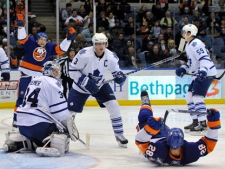 New York Islanders forwards Zenon Konopka (28) and Justin DiBenedetto, left, celebrate Konopka's second-period goal as Toronto Maple Leafs goalie James Reimer (34), Dion Phaneuf (3) and Keith Aulie (59) react during an NHL game Tuesday, March 8, 2011, in Uniondale, N.Y. (AP Photo/Kathy Kmonicek)