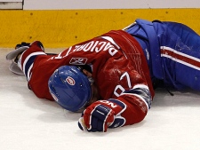 Montreal Canadiens' Max Pacioretty lays on the ice after taking a hit by Boston Bruins' Zdeno Chara during second period NHL hockey action Tuesday, March 8, 2011 in Montreal. (THE CANADIAN PRESS/Paul Chiasson)