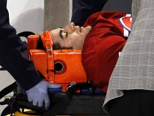 Montreal Canadiens' Max Pacioretty is wheeled away on a stretcher after taking a hit by Boston Bruins' Zdeno Chara during second period NHL hockey action Tuesday, March 8, 2011 in Montreal. Pacioretty has been diagnosed with a severe concussion and a fractured vertebra. (THE CANADIAN PRESS/Paul Chiasson)