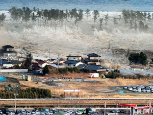 Waves of tsunami hit residences after a powerful earthquake in Natori, Japan, Friday, March 11, 2011. The largest earthquake in Japan's recorded history slammed the eastern coast Friday. (AP Photo/Kyodo News)