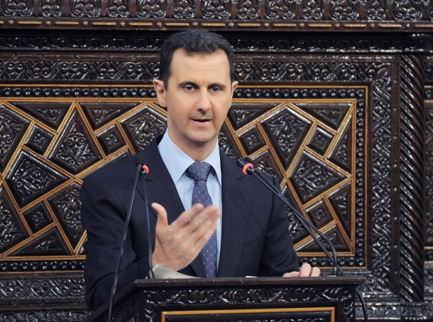 Assad says he won't step down before election