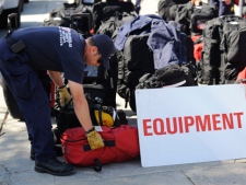 Members of the Los Angeles County urban search and rescue team prepare to deploy to Japan, Friday, March 11, 2011, in Los Angeles. (AP Photo/Gus Ruelas)