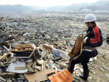 A rescuer searches for the victims of Friday's tsunami in Miyako, Japan on Monday, March 14, 2011, three days after a massive earthquake and the ensuing tsunami hit the country. (AP Photo/Kyodo News)
