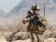 In this photo provided by ISAF Regional Command (South), U.S. Army 1st Sgt. Raymond Dakos, assigned to 1-66th Armor, 4th Infantry Division, patrols near Combat Outpost Kowall near the village of Tabin on Tuesday, March 8, 2011, in Kandahar, Afghanistan. (AP Photo/U.S. Navy Ensign Haraz N. Ghanbari) 
