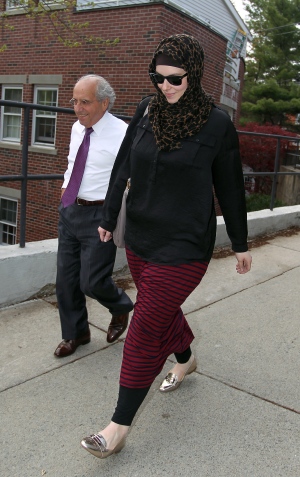 In this April 29, 2013 file photo, Katherine Russell, widow of Boston Marathon bomber suspect Tamerlan Tsarnaev, right, leaves the law office of DeLuca and Weizenbaum with Amato DeLuca, in Providence, R.I. Russell has hired New York lawyer Joshua Dratel, a criminal lawyer with experience defending terrorism cases, as she continues to face questions from federal authorities, her attorney Amato DeLuca said Wednesday. (AP Photo/Stew Milne, File)