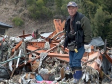 A man searches for his missing wife in Rikuzentakata, Japan on Tuesday, March 15, 2011, after Friday's massive earthquake and tsunami. (AP Photo/Kyodo News)