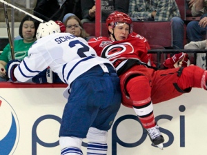 Toronto Maple Leafs' Luke Schenn (2) takes Carolina Hurricanes' Jeff Skinner off the puck during the second period of an NHL hockey game in Raleigh, N.C., Wednesday, March 16, 2011. (AP Photo/Karl B DeBlaker)