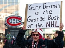 A demonstrator holds up a placard during a protest against violence in hockey and demanding tougher sanctions from the NHL against headshots Tuesday, March 15, 2011 in Montreal. (THE CANADIAN PRESS/Paul Chiasson)
