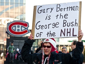 A demonstrator holds up a placard during a protest against violence in hockey and demanding tougher sanctions from the NHL against headshots Tuesday, March 15, 2011 in Montreal. (THE CANADIAN PRESS/Paul Chiasson)