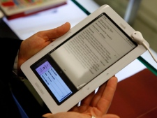 In this Dec. 7, 2009, file photo, a customer tries out a Nook electronic book reader at Barnes & Noble in New York. (AP Photo/Seth Wenig)