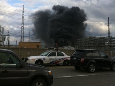 A cloud of smoke billows from a fire at a hydro station Friday, March 18, 2011. (CP24/Tom Podolec)