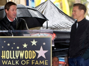 Hockey great Wayne Gretzky, left, congratulates his Canadian friend, singer Bryan Adams, as he is honored with a star on the Hollywood Walk of Fame in Los Angeles Monday, March 21, 2011. (AP Photo/Damian Dovarganes)