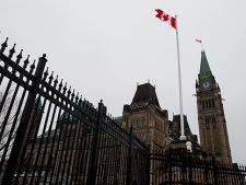 A Canadian flag flies over Parliament Hill in Ottawa on Monday, March 21, 2011. (THE CANADIAN PRESS/Sean Kilpatrick)
