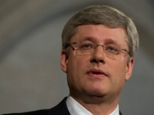 Prime Minister Stephen Harper speaks with the media outside the House of Commons on Parliament Hill in Ottawa on Wednesday, March 23, 2011. (THE CANADIAN PRESS/Sean Kilpatrick)