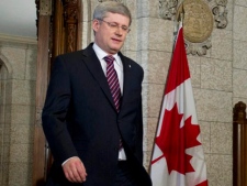 Prime Minister Stephen Harper makes his way to the podium speaks to reporters after the collapse of his Government in the foyer of the House of Commons on Parliament Hill in Ottawa on Friday, March 25, 2011. (THE CANADIAN PRESS/Sean Kilpatrick)