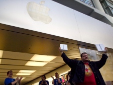 Oren Lasko emerges from Apple store in Toronto's Eaton Centre on Friday, March 25, 2011, as he becomes the first customer to buy the new iPad 2 after its release in Canada. Lasko arrived at 7:30 a.m. the previous day to ensure he secured the new second generation Apple product. (THE CANADIAN PRESS/Chris Young)