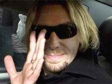 Chad Kroeger, lead singer of the band Nickelback waves as he leaves the Provincial Court in Surrey, B.C., on Thursday, May 1, 2008. (Jonathan Hayward / THE CANADIAN PRESS)