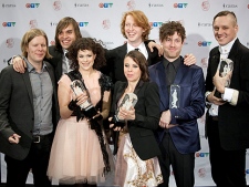 Arcade Fire pose with their awards at the 2011 JUNO Awards in Toronto on Sunday, March 27, 2011. (THE CANADIAN PRESS/Darren Calabrese)