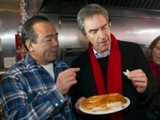 Liberal leader Michael Ignatieff samples some food at a dumpling shop as he campaigns in Toronto's Chinatown on Monday, March 28, 2011. (THE CANADIAN PRESS/Ryan Remiorz)