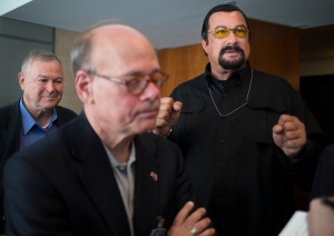 FILE - Rep. Dana Rohrabacher, left,  Rep. Steven Cohen, centre, and actor Steven Seagal, right, speak to the media after a news conference at the U.S. Embassy in Moscow, Russia on Sunday, June 2, 2013. (AP Photo/Alexander Zemlianichenko)