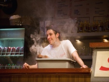 Chris Barillaro is shown in a scene from the play "Schwartz's: The Musical." There's singing and dancing and a meaty story of love and intrigue in �Schwartz's: The Musical,� a new play which is set in the iconic Montreal deli where the waiters are edgy, the seating is crowded and you're just as likely to rub shoulders with a bank robber as a bank president -- or a prime minister. (THE CANADIAN PRESS/HO-lucetg.com)