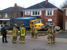 No injuries were reported after a garbage truck reversed into a home. (CP24-CTV/Ted Brooks)