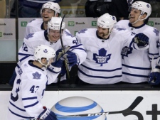 Toronto Maple Leafs' Nazem Kadri, lower left, is congratulated by teammates after beating Boston Bruins goalie Tim Thomas during the shootout in an NHL hockey game in Boston, Thursday, March 31, 2011. Kadri's shot was the only goal in the shootout, giving Toronto a 4-3 win. (AP Photo/Charles Krupa)