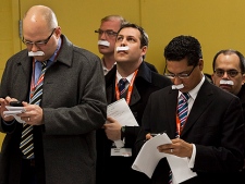 Reporters on NDP Leader Jack Layton's campaign tour sport paper moustaches as an April Fool's joke during a campaign announcement in Sudbury on Friday, April 1, 2011.  (THE CANADIAN PRESS/Andrew Vaughan)