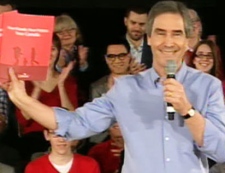 Liberal Leader Michael Ignatieff shows off the Family Care Plan at a rally in Ottawa on Sunday, April 3, 2011.