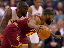 Toronto Raptors forward Reggie Evans loses contact with Cleveland Cavaliers guard Baron Davis as he drives to the hoop during first half NBA action in Toronto on Wednesday April 6, 2011. (THE CANADIAN PRESS/Frank Gunn)