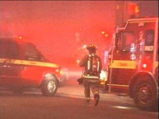 This screen grab shows a firefighter at the scene of a blaze at a roofing company near Dundas Street and Runnymede Road on Friday, April 8, 2011.