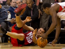 Toronto Raptors forward Joey Dorsey, right, scoops up the loose ball after a battle with New Jersey Nets guard Sasha Vujacic during an NBA game in Toronto on Sunday, April 10, 2011. (THE CANADIAN PRESS/Frank Gunn)