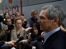 Liberal Leader Michael Ignatieff speaks to reporters on a sidewalk in downtown Ottawa Ont., on Monday, April 11, 2011. (THE CANADIAN PRESS/Sean Kilpatrick)