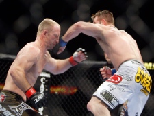 Brian Foster, right, punches Brock Larson during their mixed martial arts welterweight bout, Saturday, Nov. 21, 2009, in Las Vegas. (AP Photo/Isaac Brekken)