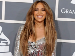 In a Feb. 13, 2011 file photo, Jennifer Lopez arrives at the 53rd annual Grammy Awards, in Los Angeles. People magazine is naming Jennifer Lopez the World's Most Beautiful Woman. The singer, actress and "American Idol" judge tops the magazine's annual list of "the World's Most Beautiful" in a special double issue. (AP Photo/Chris Pizzello, File)