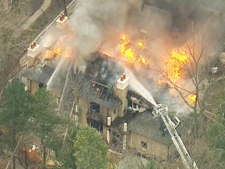 Fire crews battle a blaze at a multimillion-dollar home in Oakville on Wednesday, April 13, 2011.