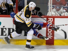 In this March 8, 2011 file photo, Montreal Canadiens' Max Pacioretty hits his head on the glass partition between the benches on a hard check from Boston Bruins' Zdeno Chara (33) during second period NHL hockey action in Montreal. Blindside hits to the head are down in the NHL, yet concussions are up. (AP Photo/The Canadian Press, Paul Chiasson, File)