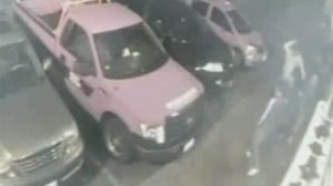 Three individuals are pictured arriving in a parking lot in the area of 3585 Keele Street in this image made from security footage released by Toronto Police on Wednesday, July, 3, 2013. 