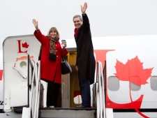 Liberal leader Michael Ignatieff and his wife Zsuzsanna Zsohar wave as they board their campaign plane at Toronto airport Wednesday, April 20, 2011. THE CANADIAN PRESS/Jonathan Hayward