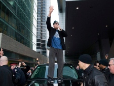 Charlie Sheen addresses his fans with a smoke outside the Ritz Carlton Hotel before walking through downtown Toronto on the way to the second night of his Violent Torpedo of Truth tour at Massey Hall in Toronto on Friday, April 15, 2011. (THE CANADIAN PRESS/Aaron Vincent Elkaim)