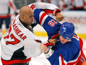his Feb. 11, 2009, file photo shows Washington Capitals left wing Donald Brashear (87) throwing a punch at New York Rangers right wing Colton Orr  (28) in the first period of an NHL hockey game at Madison Square Garden in New York. (AP Photo/Kathy Willens, File)