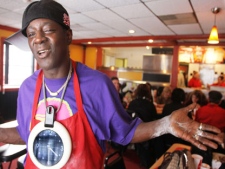 In this Jan. 24, 2011 file photo, rapper-turned-reality show star William Drayton, better known as Flavor Flav, is shown at his restaurant, Flav's Fried Chicken, in Clinton, Iowa. The restaurant has abruptly closed its doors after the reality TV star and his business partner cut ties and exchanged harsh words. Flav's Fried Chicken in Clinton, Iowa, closed on Sunday, April 24, 2011 just four months after opening to much fanfare.(AP Photo/The Quad City Times, Kevin E. Schmidt) 