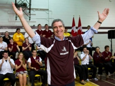 Liberal Leader Michael Ignatieff salutes the crowd after slipping on a team jersey during a townhall with high school students Wednesday, April 27, 2011 in Sault Ste Marie, Ont. (THE CANADIAN PRESS/Paul Chiasson)