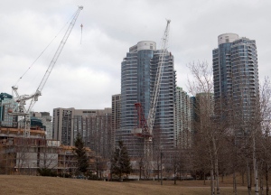 Construction cranes stand in front of condominiums in downtown Toronto on Saturday, Feb. 4, 2012. (The Canadian Press/Pawel Dwulit)