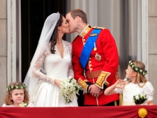 Prince William and his wife Kate, Duchess of Cambridge, kiss on the balcony of Buckingham Palace in London,Friday April 29, 2011, following their wedding at Westminster Abbey. (AP Photo/John Stillwell, Pool)