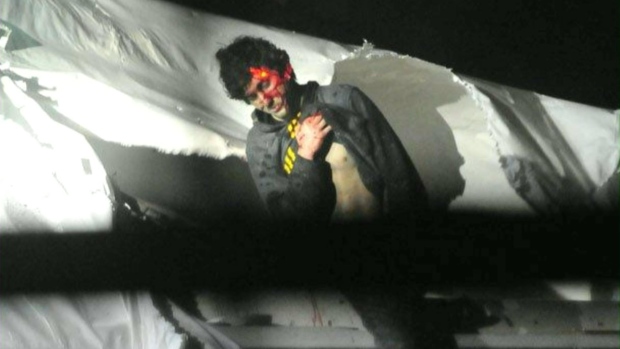 A police sniper's red laser is trained on Dzhokhar Tsarnaev's bloodied forehead on the night of his arrest in this photo by taken by police photographer Sean Murphy and published in Boston Magazine. (Sean Murphy/Boston Magazine)