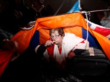 Bernadette Christie from Alberta brushes her teeth as she wakes up in a tent after camping along the Royal Wedding route in London Friday, April, 29, 2011. (AP Photo/Elizabeth Dalziel)