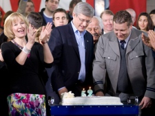 Laureen Harper cheers as Prime Minister Stephen Harper and campaign bus driver Tommy Davis cut their birthday cake following a campaign stop in Richmond Hill,Saturday April 30, 2011. Harper celebrated his 52nd birthday, Davis celebrated his 40th. THE CANADIAN PRESS/Adrian Wyld