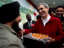 Liberal Leader Michael Ignatieff serves sweets at a restaurant Saturday, April 30, 2011 in Brampton, Ontario. (THE CANADIAN PRESS/Paul Chiasson)
